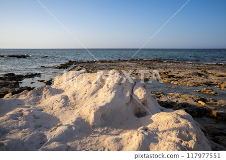 Rocky coast of a public beach, Djerba, Tunisia Rocky coast of a public beach, Djerba, Tunisia 117977551