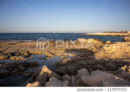 Rocky coast of a public beach, Djerba, Tunisia Rocky coast of a public beach, Djerba, Tunisia 117977552