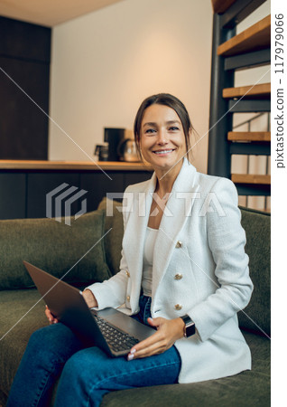 Pretty young business woman with a laptop working from home 117979066