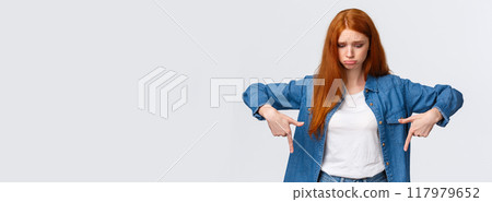 Upset, gloomy timid redhead teenage girl express pity or jealousy, regret something broken, sobbing, pouting sad and looking pointing down distressed, standing unhappy over white background Upset, gloomy timid redhead teenage girl express pity or jealousy, regret something broken, sobbing, pouting sad and looking pointing down distressed, standing unhappy over white background 117979652