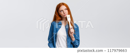 Thoughtful and creative redhead female imaging what colour paint room, holding paintbrush, look up thoughtful, thinking choices, pondering ideas, standing white background unsure Thoughtful and creative redhead female imaging what colour paint room, holding paintbrush, look up thoughtful, thinking choices, pondering ideas, standing white background unsure 117979663
