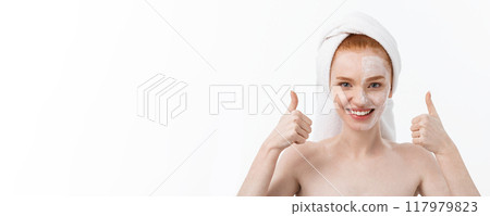 Beauty treatment. Woman applying moisturizing cream skin care product on face, making thumb up sign studio shot Beauty treatment. Woman applying moisturizing cream skin care product on face, making thumb up sign studio shot 117979823
