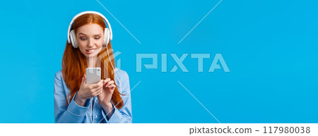 Waist-up portrait indecisive, unsure picky cute redhead female in nightwear, biting lip and looking tempting with desire smartphone screen, send risky text, listen music headphones Waist-up portrait indecisive, unsure picky cute redhead female in nightwear, biting lip and looking tempting with desire smartphone screen, send risky text, listen music headphones 117980038