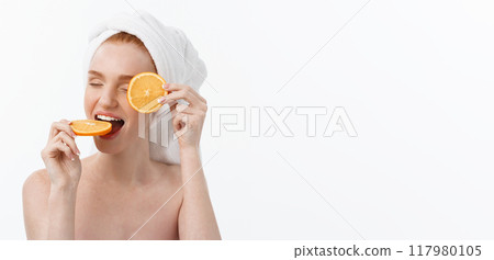 Great food for a healthy lifestyle. Beautiful young shirtless woman holding piece of orange standing against white background. 117980105