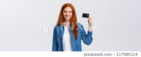 Bank, finance and education concept. Cheerful redhead girl working part-time, receive her first paycheck, holding credit card and smiling confident, standing white background delighted 117980124