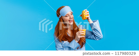 Starting morning healthy. Waist-up portrait glamour, feminine pretty foxy teenage girl prepare fresh orange juice, squeeze fruit in glass, smiling, making breakfast, wearing sleep mask and nightwear Starting morning healthy. Waist-up portrait glamour, feminine pretty foxy teenage girl prepare fresh orange juice, squeeze fruit in glass, smiling, making breakfast, wearing sleep mask and nightwear 117980329