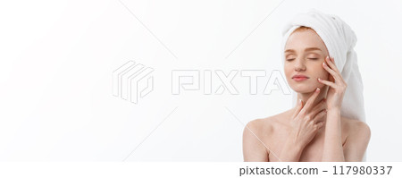 beautiful model applying cosmetic cream treatment on her face on white. beautiful model applying cosmetic cream treatment on her face on white. 117980337