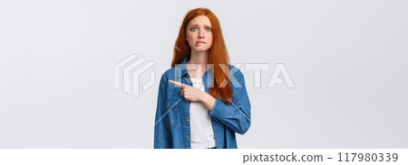 Anxious and worried cute girl having first day new college, biting lip guilty or nervous, having insecure feeling, looking scared camera, pointing finger right, standing white background Anxious and worried cute girl having first day new college, biting lip guilty or nervous, having insecure feeling, looking scared camera, pointing finger right, standing white background 117980339