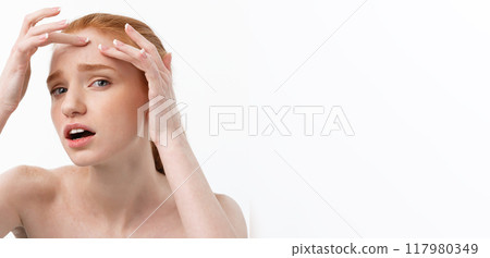 Young caucsian woman squeezes acne on the face of beauty 117980349