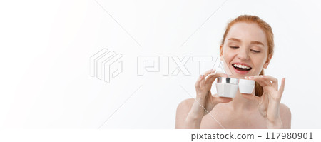 portrait of beautiful woman smiling while taking some facial cream isolated on white background with copy space. 117980901