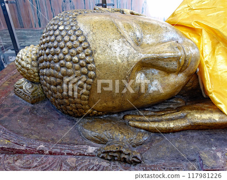 The north face of the Buddha's head enshrined in the Nirvana Hall of Kushinagar, a Buddhist holy site in India. The face of the Nirvana section, which is tranquilized to the west. The north face of the Buddha's head enshrined in the Nirvana Hall of Kushinagar, a Buddhist holy site in India. The face of the Nirvana section, which is tranquilized to the west. 117981226