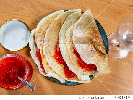 Crepes served in a plate with red caviar 117983819