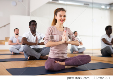 People exercising lotus asana in gym People exercising lotus asana in gym 117984097