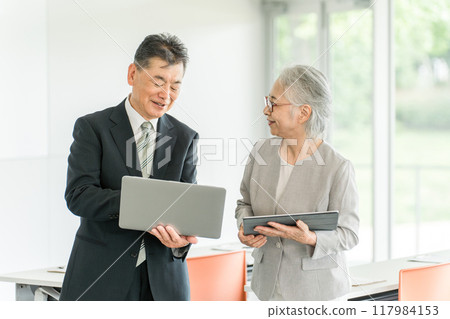 Senior generation businessmen and women in an office/conference room (reemployment, second career, re-employment) Senior generation businessmen and women in an office/conference room (reemployment, second career, re-employment) 117984153