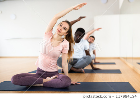 People exercising lotus asana in gym People exercising lotus asana in gym 117984154