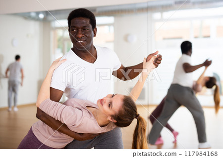 Adult people dancing slow ballroom dances in pairs 117984168