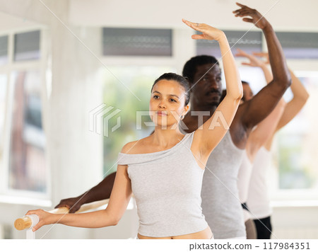 Group of men and women will learn to stand in third position during ballet rehearsal Group of men and women will learn to stand in third position during ballet rehearsal 117984351