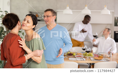 Two women greet each other when meeting 117984427