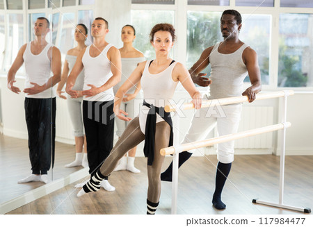 Woman and man dancers practice batman tandu jete Woman and man dancers practice batman tandu jete 117984477