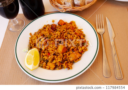 Traditional Spanish dish is Paella with meat 117984554