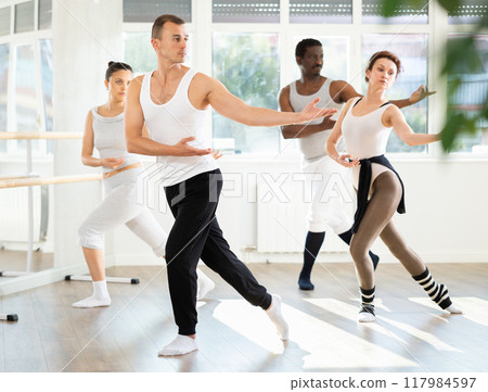 Motivated young adult man participating in group ballet class 117984597