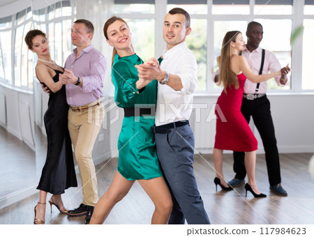 Woman and young man practicing waltz in dancing studio Woman and young man practicing waltz in dancing studio 117984623