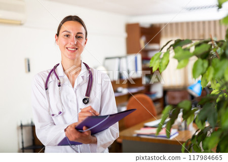 Portrait of female doctor wearing uniform with folder 117984665