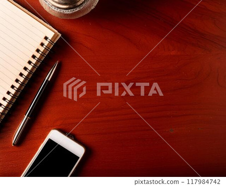 Smartphone, notebook and pen on a desk 117984742