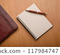 Open spiral notebook and pen 117984747