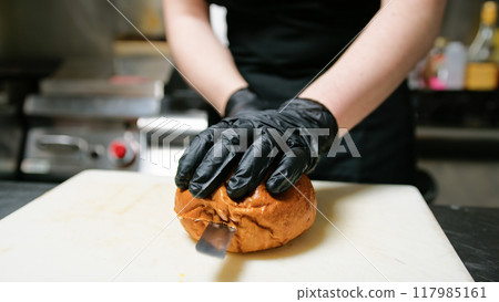 Knife Cutting Of A Bread Bun To Start Dish Preparation Knife Cutting Of A Bread Bun To Start Dish Preparation 117985161
