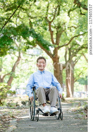 Senior man self-propelling wheelchair, full body 117985557