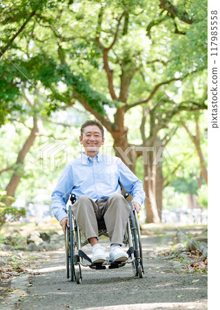Senior man self-propelling wheelchair, full body 117985558