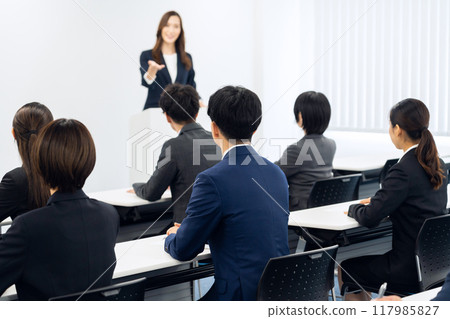 Male and female businessmen receiving training Male and female businessmen receiving training 117985827