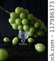 Beautiful fresh Shine Muscat grapes on a glass container, vertical composition 117986373