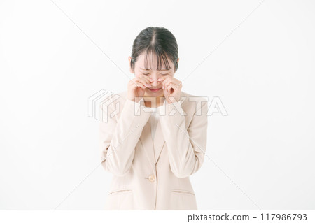 A young woman posing as if she is crying A young woman posing as if she is crying 117986793