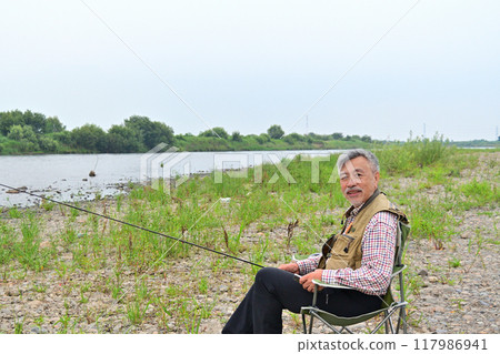 Veteran fly fishing angler 117986941