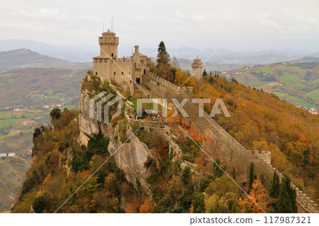 Republic of San Marino surrounded by Italy. View of the Cesta Tower on the cliff from Guaita Fortress on Mount Titano, a World Heritage Site. Republic of San Marino surrounded by Italy. View of the Cesta Tower on the cliff from Guaita Fortress on Mount Titano, a World Heritage Site. 117987321