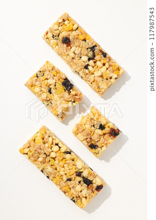 Delicious granola bars on a white background 117987543