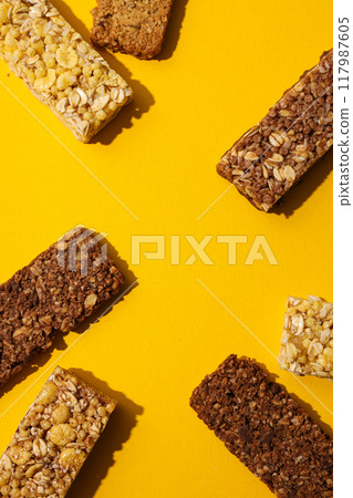 Delicious granola bars on a yellow background 117987605