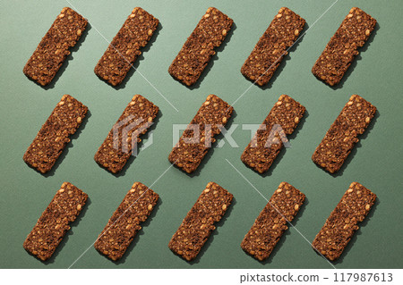 Tasty granola bar on a dark background Tasty granola bar on a dark background 117987613