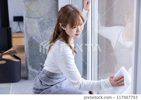 Woman cleaning windows Woman cleaning windows 117987783