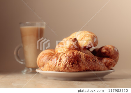 Freshly baked croissants and latte. 117988550