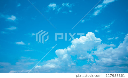 Cumulus clouds and contrails floating in the late summer blue sky, light color 117988861