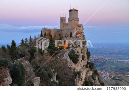 Republic of San Marino surrounded by Italy: View of the Roccaguaita Fortress at dawn on the cliffs of Mount Titano, a World Heritage Site Republic of San Marino surrounded by Italy: View of the Roccaguaita Fortress at dawn on the cliffs of Mount Titano, a World Heritage Site 117988990