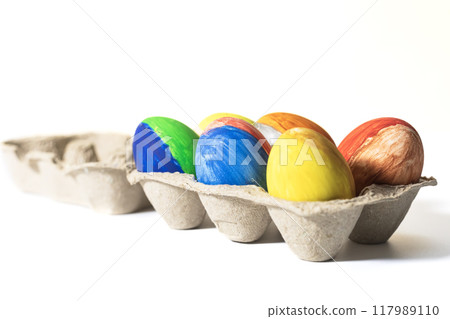 Happy Easter. Colorful easter eggs in egg carton isolated on white background. 117989110