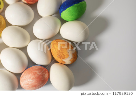 Colorful easter eggs on a white background with copy space. 117989150