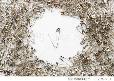 Open safety pins on white background. Open safety pins on white background. 117989704