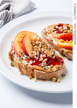 Peanut butter and jam jam with peach and nuts, white background. Peanut butter and jam jam with peach and nuts, white background. 117990913