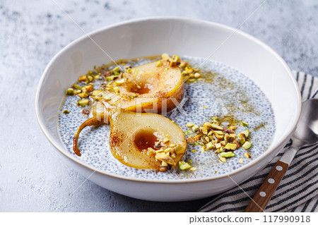 Chia pudding with caramelized pear and pistachio. 117990918