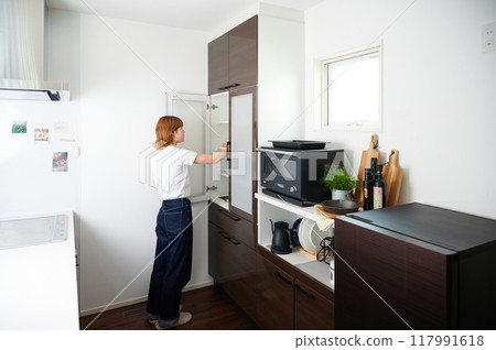 Woman opening cupboard, housework, cooking, life 117991618